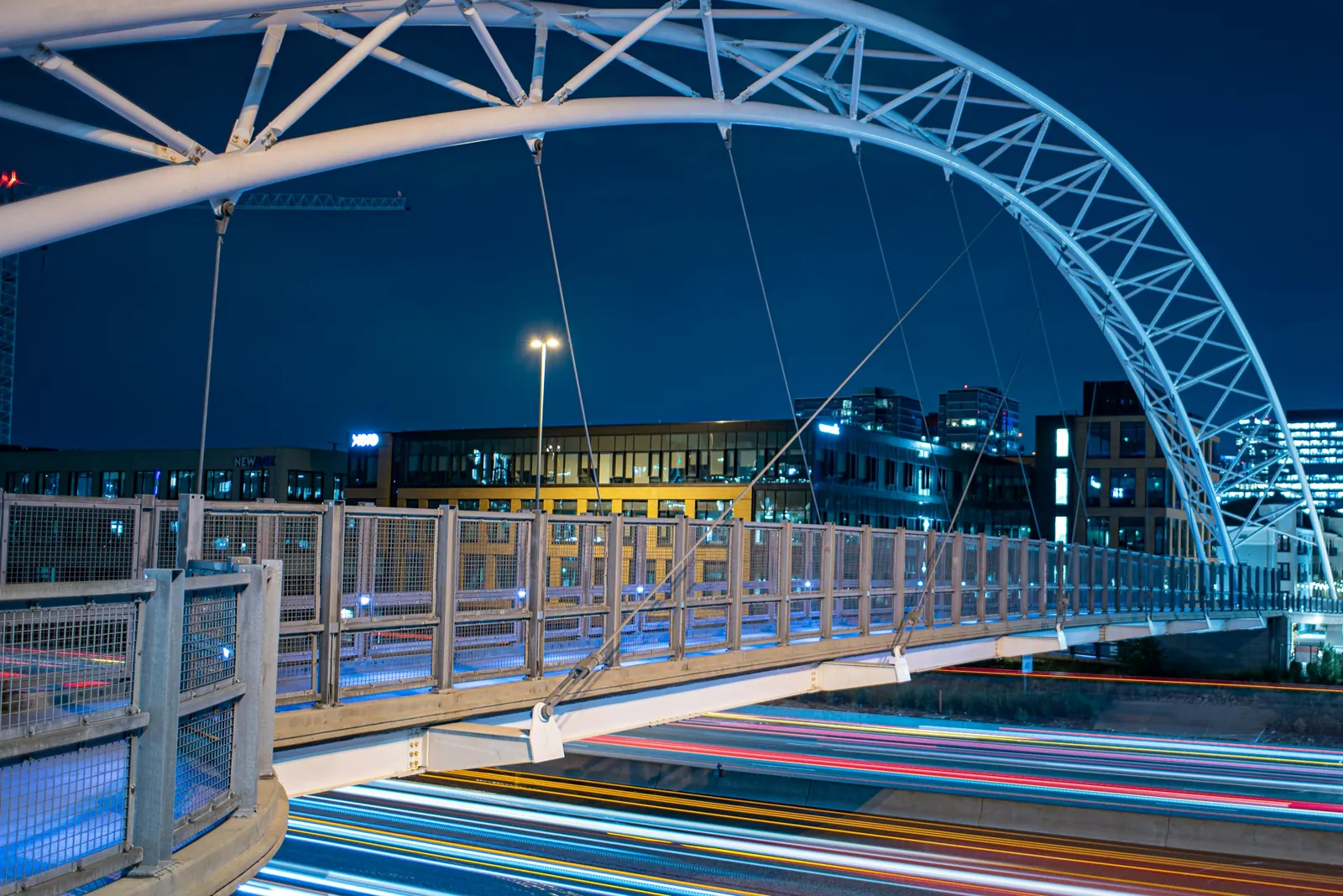 The Highland Bridge over I-25 at night, the walking link between LoHi and Commons Park